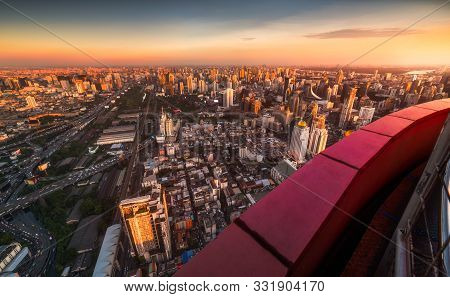 Wide Angle Skyscraper View Of Bangkok, Thailand. Cityscape In Evening Golden Light At Sunset.