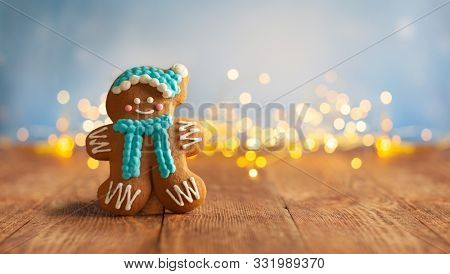 Christmas gingerbread cookies with Christmas decorations on wooden background. Traditional Christmas baking.