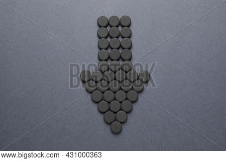 Arrow Made Of Activated Charcoal Pills On Grey Background, Flat Lay. Potent Sorbent