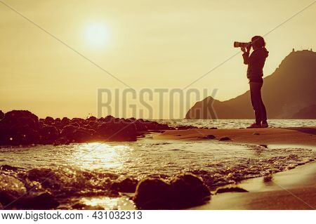 Tourist Woman With Camera Taking Travel Photo On Monsul Beach At Sunset. Cabo De Gata Nijar Natural 