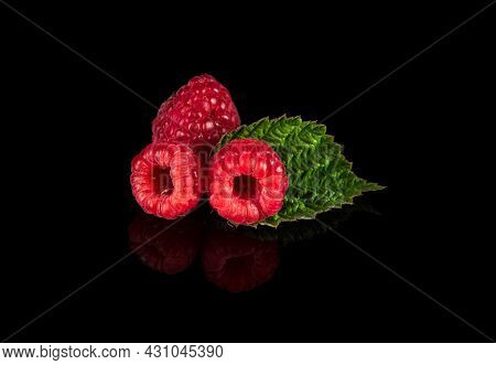 Raspberry Isolated. Raspberries With Leaf Isolate. Raspberry With Leaf Isolated On Black Background