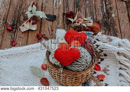 Autumn Knitting Of Warm Clothes. Woolen Balls Of Knitting Needles Knitted Hearts. Self-made Things W
