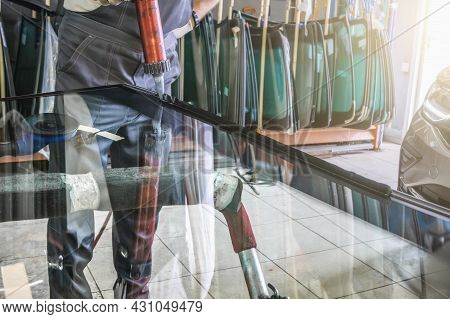 Process Of Preparing Windshield For Replacement In Car Service. Worker Applies Special Adhesive Seal