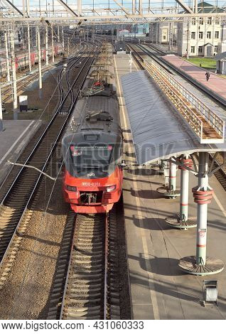 Novosibirsk, Siberia, Russia - 05.25.2020: The Modern Red Train Stands On The Tracks At The Passenge