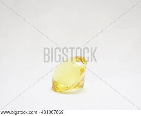 Beautiful, Majestic And Perfectly Cut Yellow Glass Diamond Isolated In A White Background