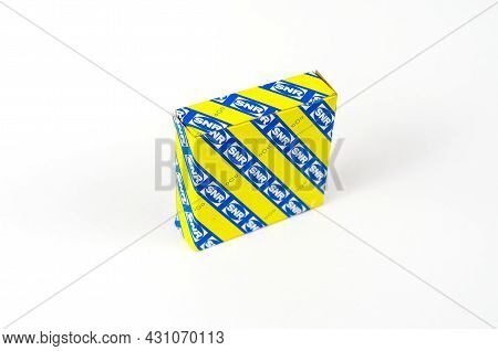 New Ball Bearing In A Square Paper Yellow And Blue Box On A White Background. Auto Part Manufactured