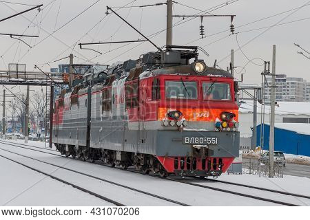 Electric Locomotive Vl80s551 Rides Through A Winter City. Close-up. A Gray Winter Cityscape. Krasnod