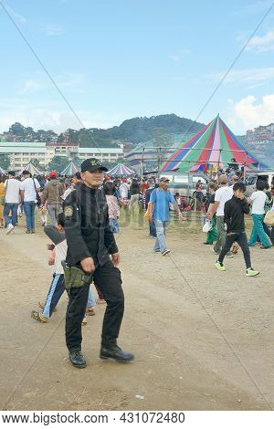 A Male Police And People In An Event In Benguet, Philippines, Southeast Asia. Photo Taken On Novembe