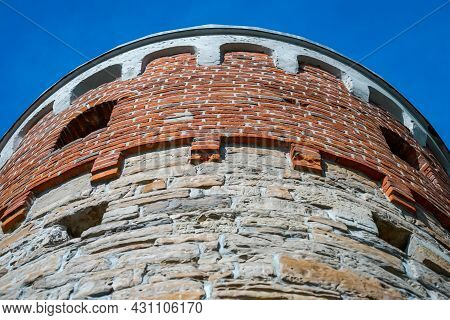 The Top Of A Round Tower, A Brick Tower With A Window.
