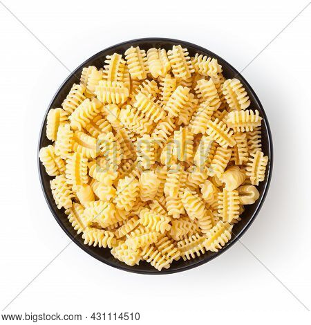 Uncooked Radiatori Pasta In Black Bowl Isolated On White Background With Clipping Path