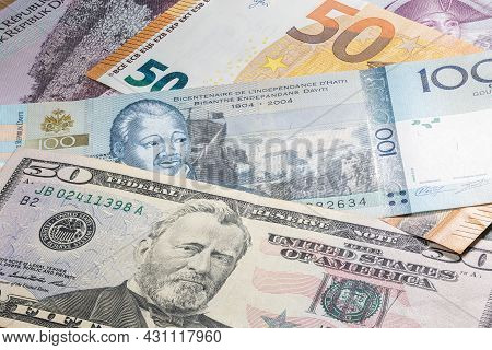 Close Up To 100 Gourde Of The Republic Of Haiti Between 50 Us Dollar And 50 Euro Banknotes. One Hund