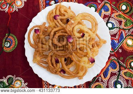 Popular And Traditional Sweet Dish Jalebi Or Zulbia Deep Fried In Ghee Decorated With Rose Petals Wi