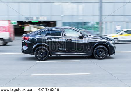 Moscow, Russia - August 2021: Black Shiny Bmw X6 M Third Generation G06 Driving Fast On The Open Roa