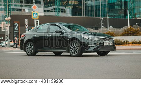 Black Kia Optima Sedan Car 2018 Facelift On City Street. Front Side View Of Kia K5 On Urban Backgrou