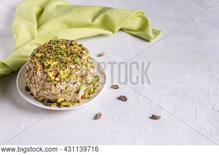 Sesame Halva With Pistachios On Top, Few Scattered Nuts, Green Linen Napkin And Copy Space. Turkish 
