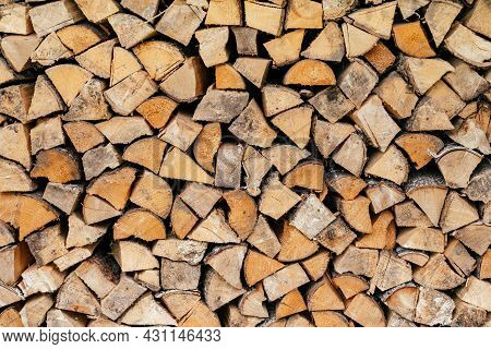 Texture Background Image Of Chopped Firewood Stacked In A Woodpile. Copy Space
