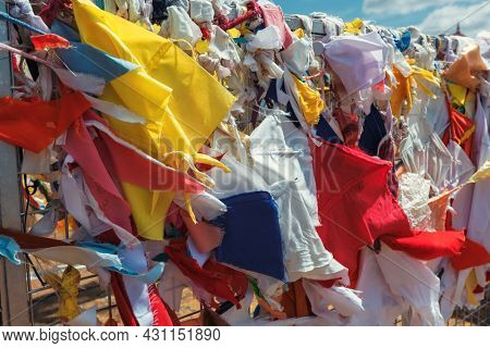 Multicolored fabric rags flags in Buddhist temple and pilgrimage site Ruwanweliseya Dagoba. Anuradhapura, Sri Lanka