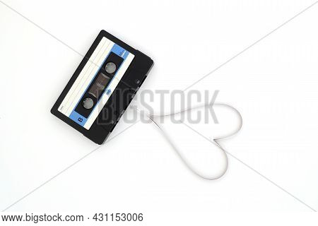 Retro Audio Stereo Mono Blue Cassete With Magnetic Tape In Shape Of Heart. Top View At The Cassete O