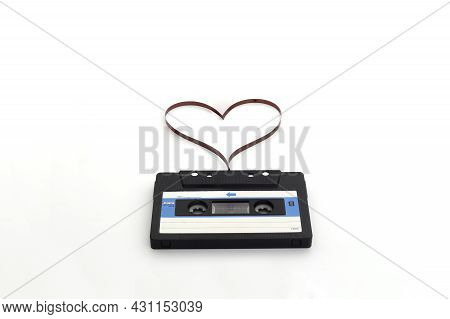 Retro Audio Stereo Mono Blue Cassete With Magnetic Tape In Shape Of Heart. Top View At The Cassete O