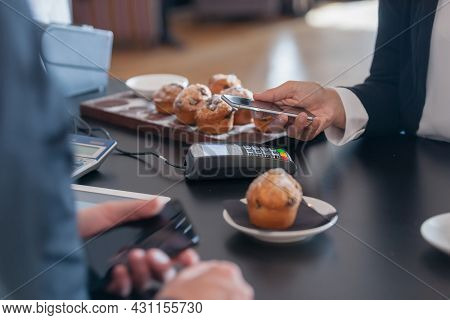 Focus On Terminal, Phone And Hand In Making Contactless Payment In Cafe With Mobile Phone A Growing 