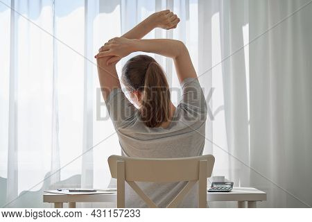 Back View Of Unrecognizable Young Woman Touching Albow Feeling Back Ache And Discomfort. Tired Of Wo