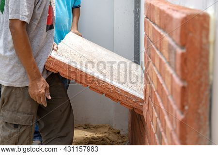 Thai Labour Are Installed Foam Brick Board On The Cement Wall
