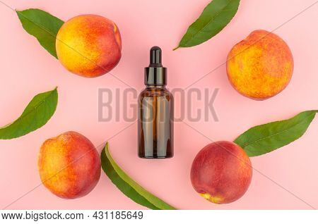 Natural Peach Oil. Natural Cosmetics, Hair Care. Bottle With Essential Peach Oil, Peaches And Green 