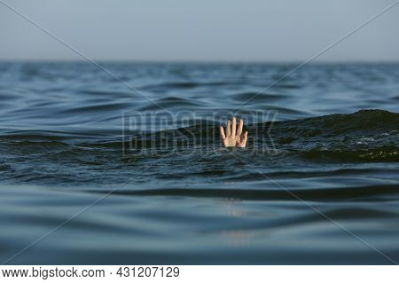Drowning Woman Reaching For Help In Sea