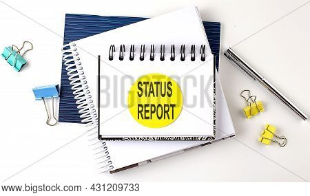 Sticker With Status Report Text On The Notebooks On White Background