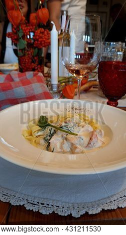 Salmon Pasta, Tagliatelle With Fish And Creamy Sauce. Italian Dinner With Seafood.