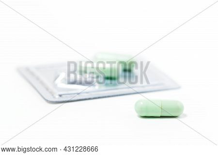 Green Chiretta Herbal Capsule On White Background With Copy Space For Healthcare And Medical Concept