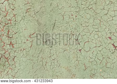 Background Of Iron Covered With Light Green Paint With Traces Of Peeling Close-up