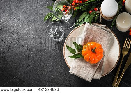 Autumn Table Setting With Plate, Pumpkin And Candles.