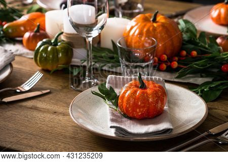 Autumn Table Setting With Plate, Pumpkin And Candles.