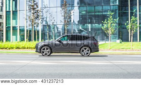 Genesis Gv80 Suv Is Driving In The Cityscape. It Is A Mid-size Luxury Crossover Suv Manufactured By 