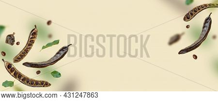 Creative Composition. Floating Organic Carob Pods, Seeds, Leafs. Food Background. Natural Vegan Eati