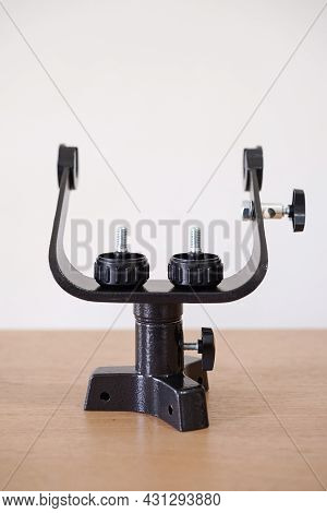 Yoke Altazimuth Mount, Thumb Screw, And Vertical Fine Adjustment Rod. Telescope Parts On Wooden Tabl