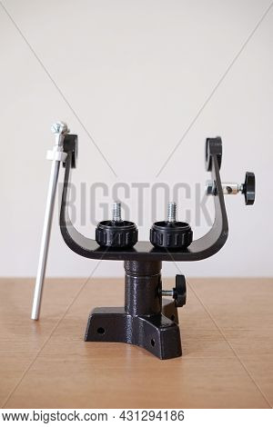Yoke Altazimuth Mount, Thumb Screw, And Vertical Fine Adjustment Rod. Telescope Parts On Wooden Tabl