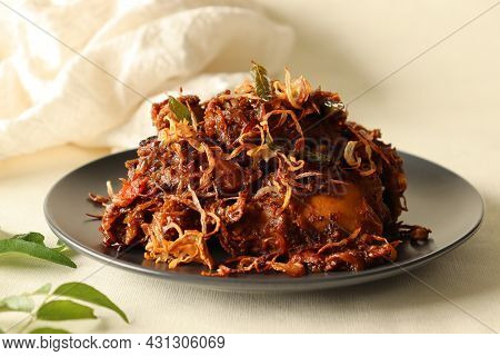 Kerala Style Spicy Chicken Roast Garnished With Caramelized Onions. Popular Name Is Kozhi Varuthathu