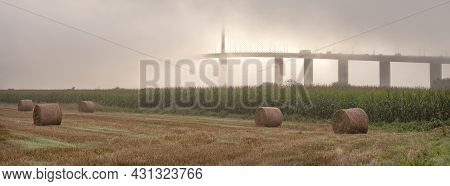 Meadow Landscape And Pont De Brotonne Over River Seine In French Normandy During Misty Sunrise