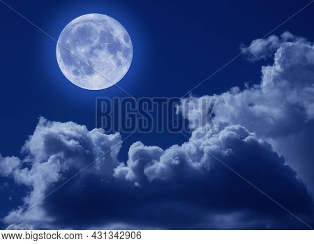 A Full Moon In A Tragic Night Sky With Clouds. A Halloween Scene With A Copy Of The Space