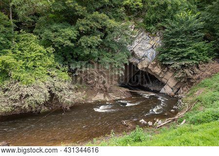 Han-sur-lesse, Wallonia, Belgium - August 9, 2021: Lesse River Enters The Local Cave System Through 