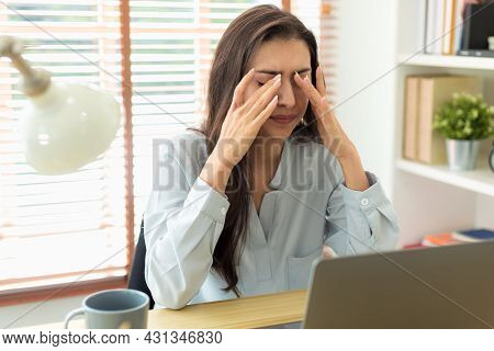 Adult Caucasian Woman Has A Headache From Working Too Long At Her Laptop. Business Women Is Migraine