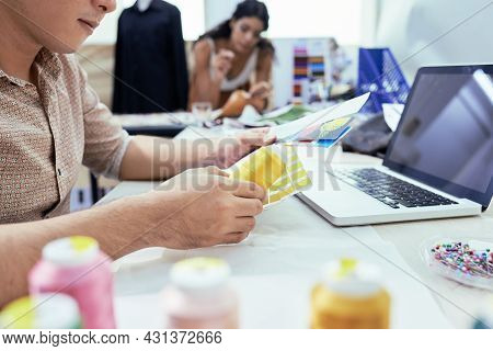 Manager Of Sewing Workshop Checking Palatte Of Color Samples And Ordering New Shapes Of Threads Onli