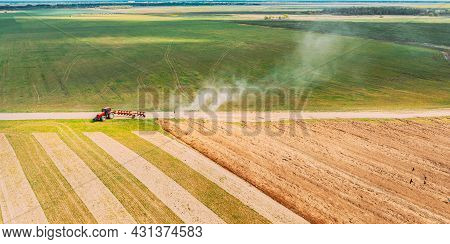 Aerial View. Tractor Plowing Field In Spring Season. Beginning Of Agricultural Spring Season. Cultiv