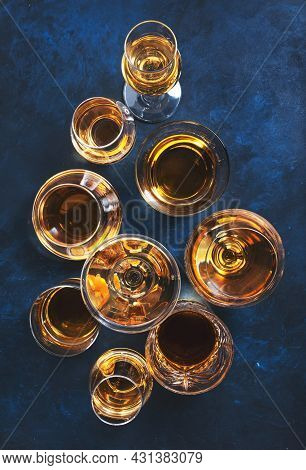 Strong Alcohol Drinks, Hard Liquors, Spirits And Distillates Iset In Glasses: Cognac, Scotch, Whiske