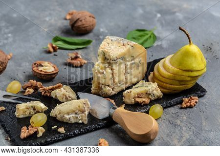 French Blue Cheese Roquefort, Made From Sheep Milk With Walnuts Honey And Pear. Top View.