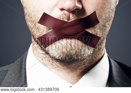 Close Up Of Taped Caucasian Businessman Mouth. Silence And Speech Censorship Concept