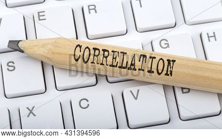 Text Correlation On Wooden Pencil On White Keyboard. Business