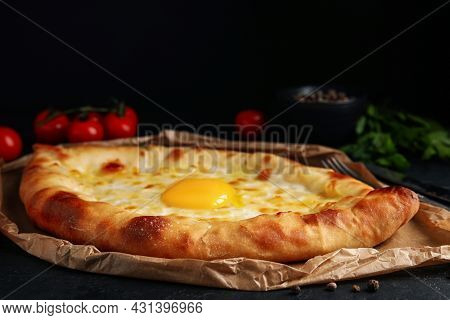 Fresh Delicious Adjarian Khachapuri Served On Black Table